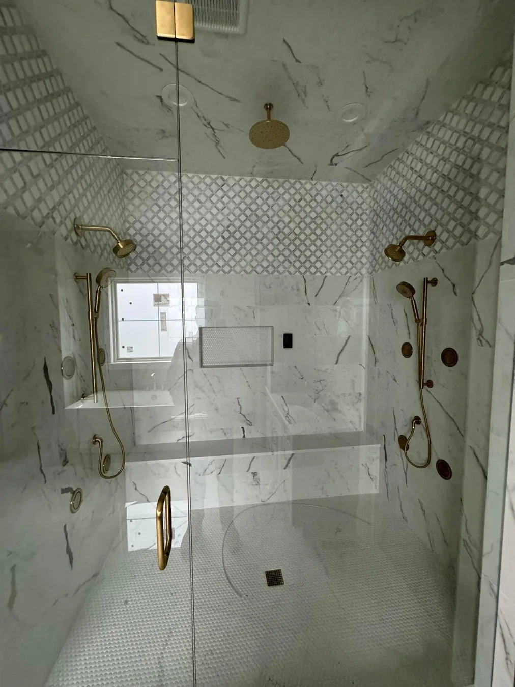 Luxury marble shower with gold fixtures